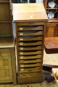Kenrick & Jefferson early 20th Century oak easel topped tambour front filing cabinet,