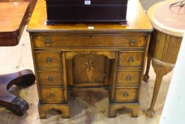 Good quality walnut kneehole desk having frieze drawer above twin banks of three drawers and