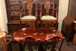 Yew twin pedestal extending dining table and six shield back chairs including two carvers