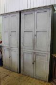Two Victorian painted pine four door cupboards fitted with shelves,