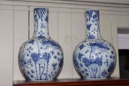 Pair of large Oriental pottery bulbous bottle neck vases decorated with fish and aquatic fauna