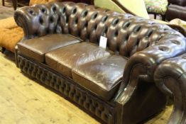 Brown leather deep buttoned and brass studded three seater Chesterfield settee