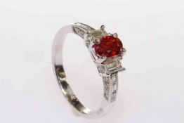 18 carat gold, orange oval sapphire and baguette diamond shoulder ring,