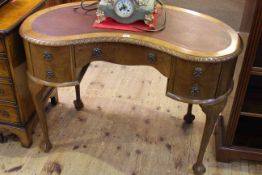 Walnut five drawer kidney shaped desk on ball and claw legs bearing label for A.