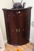 19th Century inlaid mahogany two door bow front corner wall cupboard, 105.