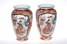 Pair of Oriental pottery vases with floral and figural design
