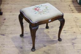 Mahogany cabriole leg stool of serpentine form with floral needlework seat