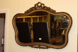 Gilt mirror with ribbon crest