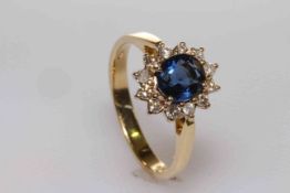 18 carat gold, oval sapphire and round brilliant cut diamond cluster ring, sapphire approximately 1.