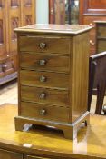 Miniature mahogany chest of five drawers on bracket feet,