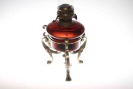 Ornate brass three paw foot oil lamp with coloured glass reservoir