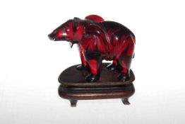 Chinese cherry amber coloured model of an elephant, on wooden stand, early 20th Century, overall 11.