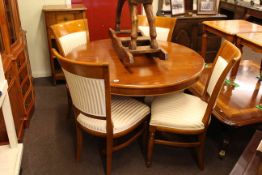 Yew circular extending dining table and four Regency stripe chairs