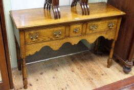 Period style oak three drawer side table on turned legs,
