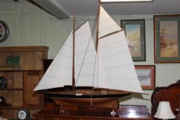 Large model pond yacht on stand with sails