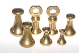Seven antique brass weights