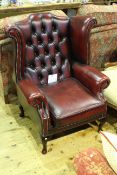 Ox blood deep buttoned leather wing back chair on cabriole legs
