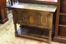 Period style carved oak two door hall cupboard with undershelf and turned supports, 78.5cm by 98.