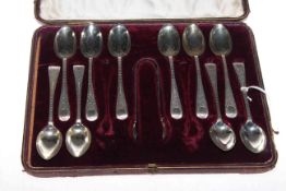 Set of ten silver teaspoons and sugar tongs,