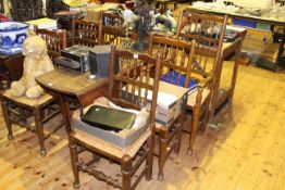 Oak drop leaf dining table on pad feet and six oak rush seated dining chairs