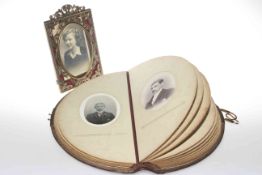 Edwardian demi lune leather photograph album and a brass photograph frame (2)