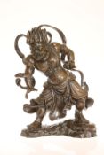 A JAPANESE PATINATED BRONZE FIGURE OF A DEITY, probably early 20th century, in ferocious pose,