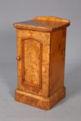 A VICTORIAN POLLARD OAK POT CUPBOARD, with pointed panel door and plinth base. 81.