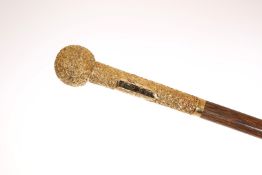 A FINE LATE VICTORIAN GENTLEMAN'S CANE, with yellow metal handle, chased with scrolls,
