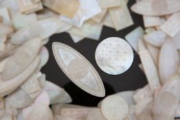 A LARGE QUANTITY OF CHINESE MOTHER OF PEARL GAMING TOKENS, of varying shapes, engraved with flowers,