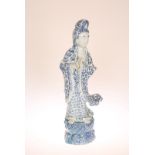 A LARGE CHINESE BLUE AND WHITE FIGURE OF QUAN YIN, modelled in flowing robes holding a bottle vase.