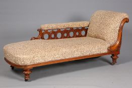 A VICTORIAN WALNUT AND UPHOLSTERED CHAISE LONGUE, the back with openwork Vitruvian scroll,