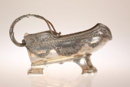 AN EARLY 20th CENTURY SILVER-PLATED WINE BOTTLE HOLDER,