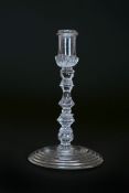 A MULTI-KNOPPED TAPERSTICK, CIRCA 1730-40, the nozzle with ring neck,