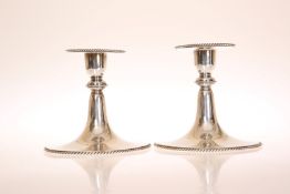 A PAIR OF EDWARDIAN SILVER CANDLESTICKS, Wakely & Wheeler, London 1908, with ropetwist edges. 11.