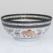 AN ARMORIAL BOWL IN CHINESE EXPORT STYLE, late 19th Century, painted inside and out with flowers,