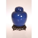 A CHINESE BLUE GLAZED GINGER JAR AND COVER, probably 19th Century, the base with concentric circles,