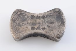 A CHINESE WHITE METAL TOKEN, of waisted rectangular form, incised with calligraphy. Length 7cm, 7.