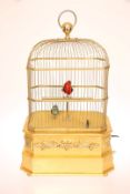 A COIN-OPERATED GILTWOOD AND GILT-METAL SINGING BIRD AUTOMATON, the domed cage enclosing two birds,