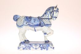 A DUTCH DELFT MODEL OF A HORSE, probably late 18th Century, modelled with right foreleg raised,
