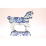 A DUTCH DELFT MODEL OF A HORSE, probably late 18th Century, modelled with right foreleg raised,