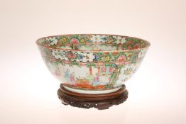 A CHINESE CANTON FAMILLE ROSE BOWL, typically decorated with panels of figures, foliage,