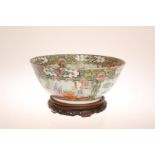 A CHINESE CANTON FAMILLE ROSE BOWL, typically decorated with panels of figures, foliage,