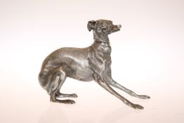 A WHITE METAL MODEL OF A GREYHOUND, cast in a realistic pose, seemingly unmarked. 8.