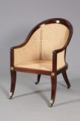 AN EARLY 19TH CENTURY BERGERE, of horseshoe shape with spherical terminals to the arms,