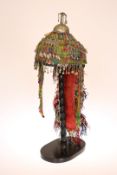 A 20TH CENTURY TURKMENISTAN FEMALE BRIDAL HEADDRESS MUTZE, decorated with traditional ornaments,