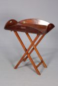 A 19TH CENTURY MAHOGANY BUTLERS TRAY, on a folding X-form stand, the tray with hinged sides.