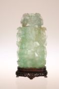 A CARVED JADE VASE AND COVER, of flattened cylindrical form,