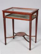 AN EARLY 20TH CENTURY MAHOGANY BIJOUTERIE TABLE, the hinged top with bead and reel edge,