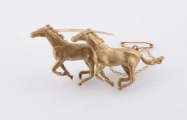 A YELLOW GOLD BROOCH, modelled as two galloping horses,