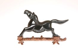 A CHINESE CARVED MODEL OF A HORSE, on a wooden stand, probably 19th Century.